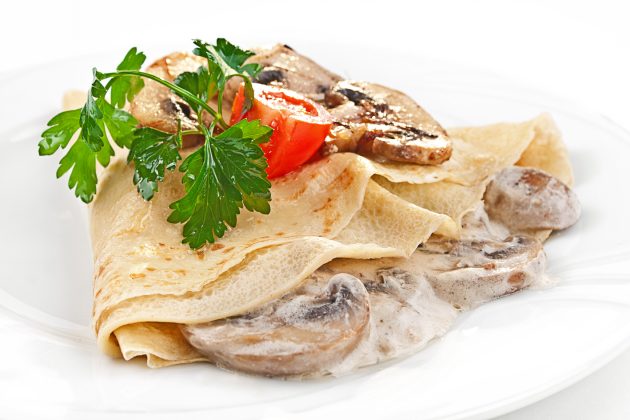 Pancakes with mushrooms and cheese sauce